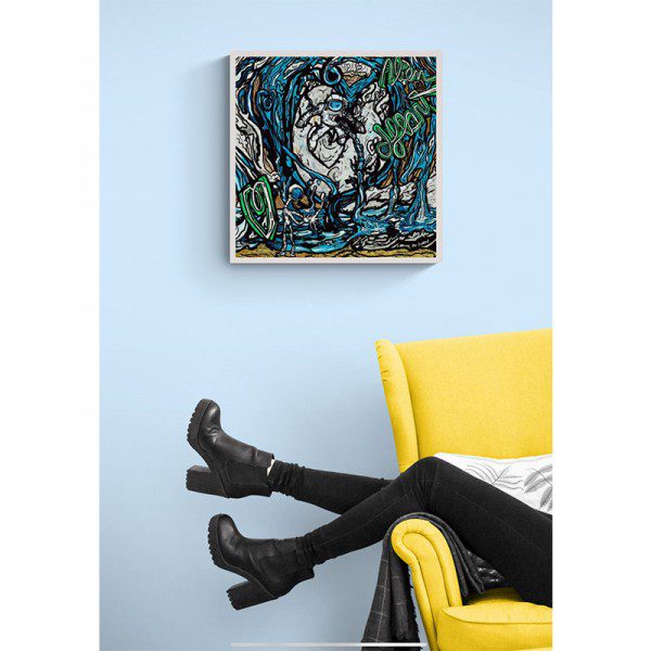 A woman sits on a yellow chair next to an Alien Heart Framed Print.