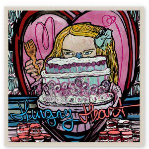 A painting of a girl holding a cake with the words Hungry Heart Framed Print.