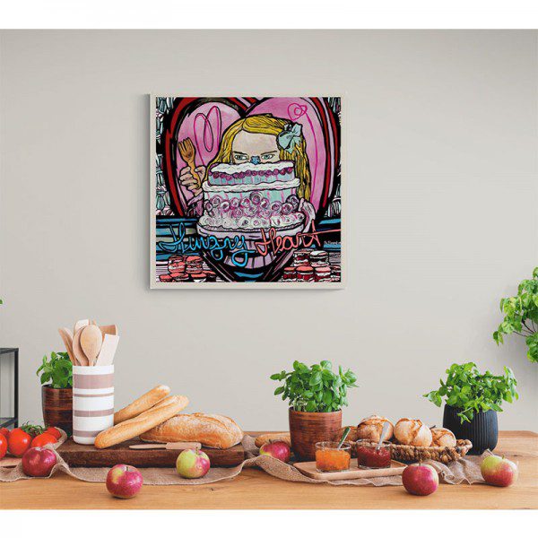 A Hungry Heart Framed Print of a girl with a cake on a table.
