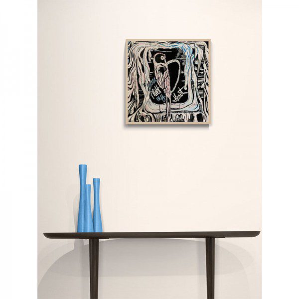 A blue vase sits on a table next to a Melted Heart Framed Print.