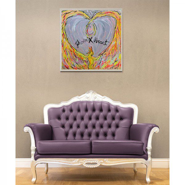 A purple couch in front of a Phoenix Heart Print.