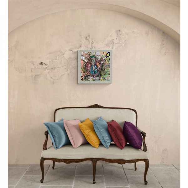 A Regal Heart Framed Print with colorful pillows in front of a wall.
