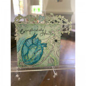 A card with the words 'complicated heart' on it.