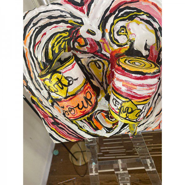 A painting of two Hearts Soup cans on an easel.