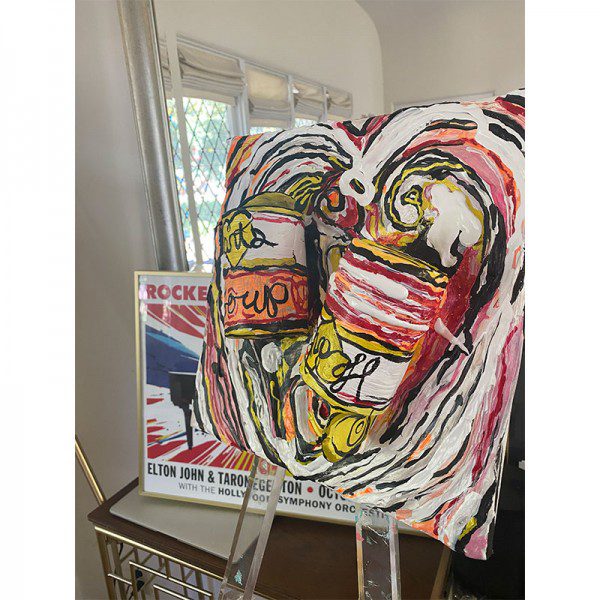 A painting of a Hearts Soup can on an easel.