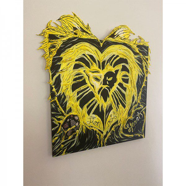 A painting of a yellow and black Lion Heart on a wall.