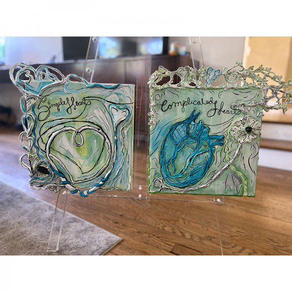 A pair of Simple Heart cards with blue and green hearts on them.