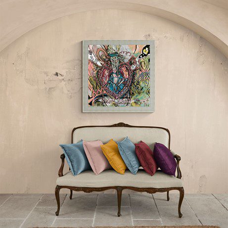 A unique art piece that has been custom-framed and placed on an otherwise empty wall above a multi-seater chair.