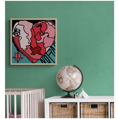 A beautiful framed painting of a heart-shaped map placed above a crib and globe.
